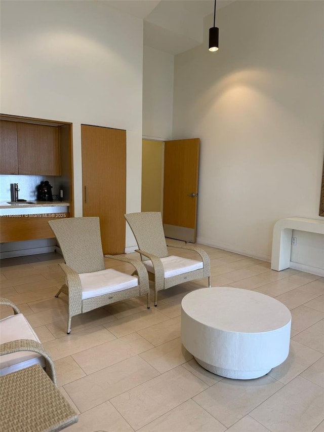 8911 Collins Ave Unit 1103, Surfside, FL 33154 - living area with a high ceiling and light tile patterned floors