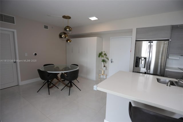 325 S Biscayne Blvd Unit 1822, Miami, FL 33131 - kitchen with stainless steel fridge, pendant lighting, light countertops, and light tile patterned floors