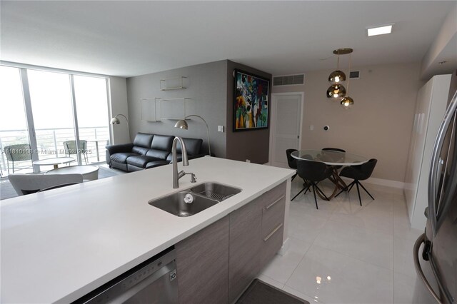 325 S Biscayne Blvd Unit 1822, Miami, FL 33131 - kitchen featuring a sink, expansive windows, light countertops, light tile patterned flooring, and hanging light fixtures