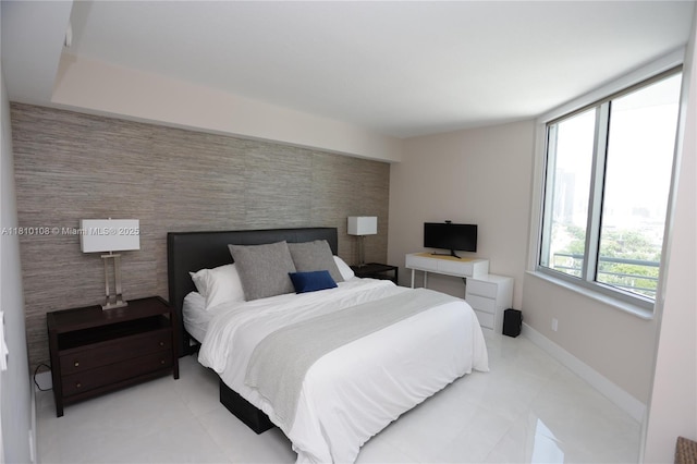 325 S Biscayne Blvd Unit 1822, Miami, FL 33131 - bedroom with an accent wall, baseboards, and light tile patterned floors