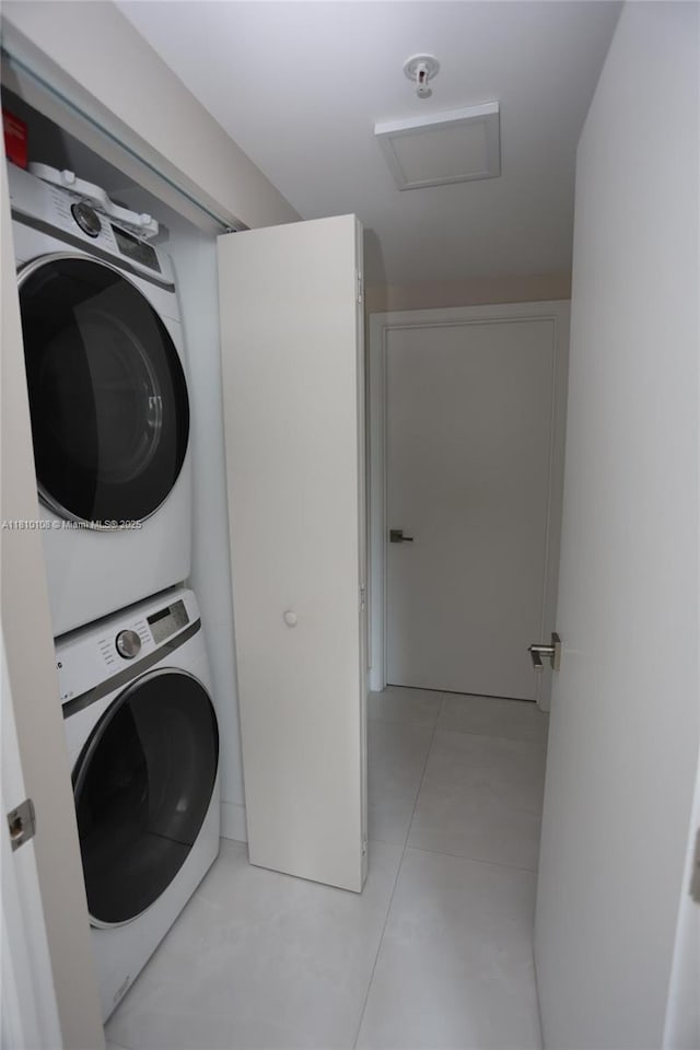 325 S Biscayne Blvd Unit 1822, Miami, FL 33131 - laundry room featuring stacked washer and clothes dryer, attic access, and light tile patterned floors