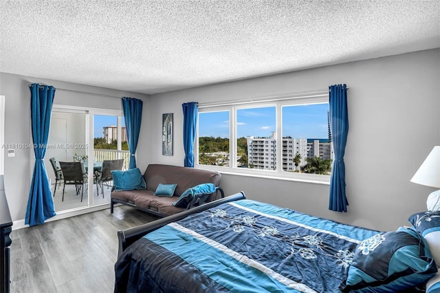 720 Bayshore Dr Unit 804, Fort Lauderdale, FL 33304 - bedroom with access to exterior, a textured ceiling, and wood finished floors