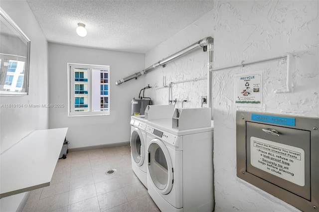 720 Bayshore Dr Unit 804, Fort Lauderdale, FL 33304 - washroom featuring washer and dryer, plenty of natural light, a textured ceiling, light tile patterned flooring, and water heater