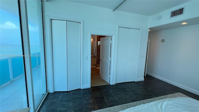 700 NE 25th St Unit 1703, Miami, FL 33137 - unfurnished bedroom featuring multiple closets