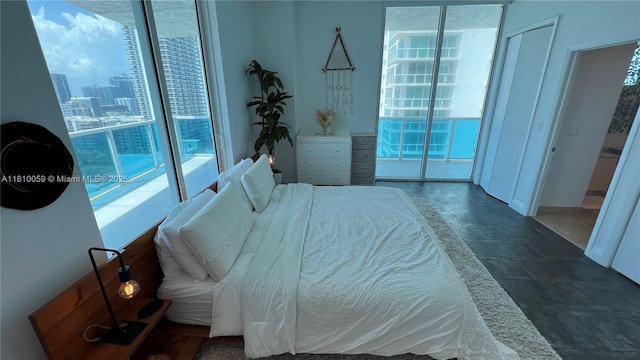 700 NE 25th St Unit 1703, Miami, FL 33137 - bedroom with stone tile floors, access to outside, and multiple windows
