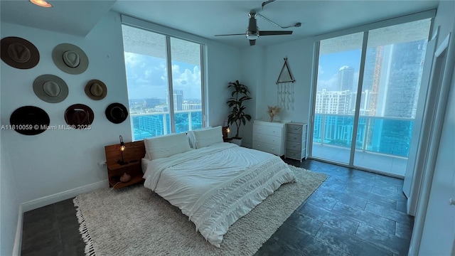 700 NE 25th St Unit 1703, Miami, FL 33137 - bedroom with a view of city, access to outside, expansive windows, ceiling fan, and baseboards