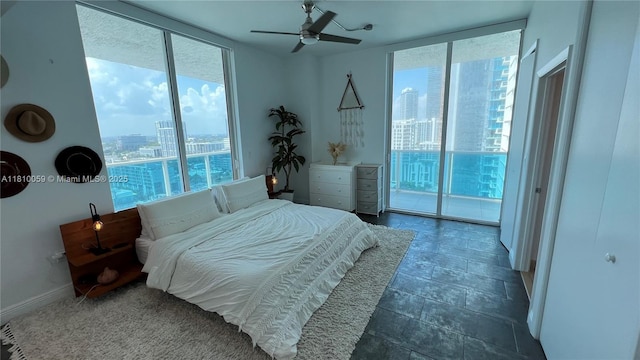 700 NE 25th St Unit 1703, Miami, FL 33137 - bedroom featuring a view of city, access to exterior, floor to ceiling windows, ceiling fan, and baseboards