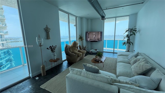 700 NE 25th St Unit 1703, Miami, FL 33137 - living room with plenty of natural light, expansive windows, wood finished floors, and a water view