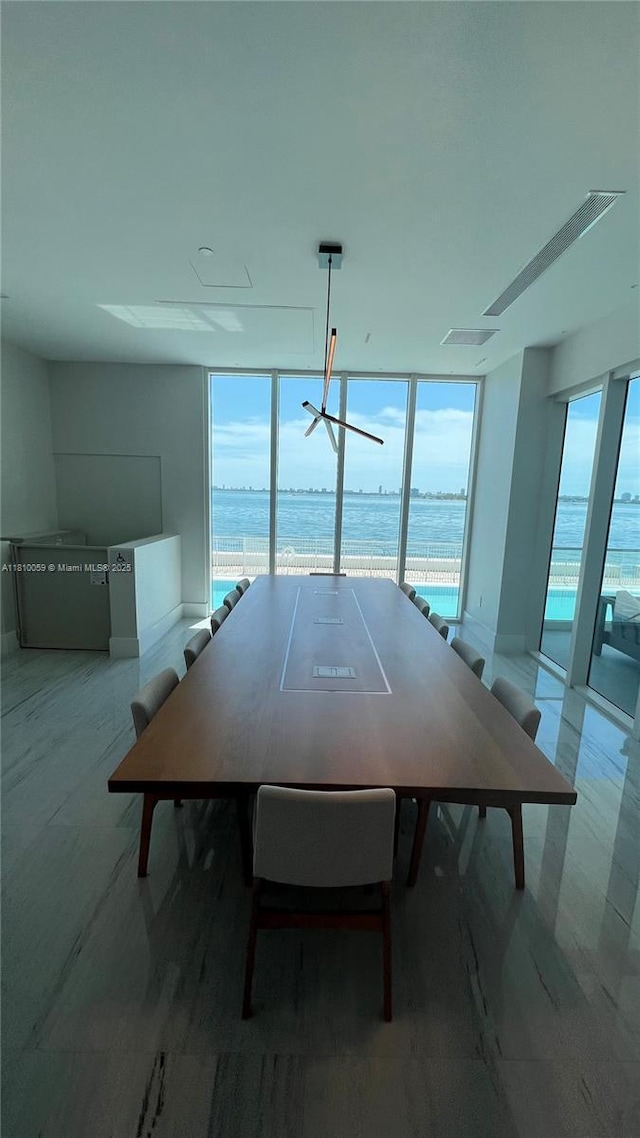 700 NE 25th St Unit 1703, Miami, FL 33137 - unfurnished dining area featuring a water view and baseboards