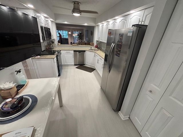 7443 Fairfax Dr Unit 208, Tamarac, FL 33321 - kitchen featuring black appliances, white cabinetry, light countertops, and a textured ceiling