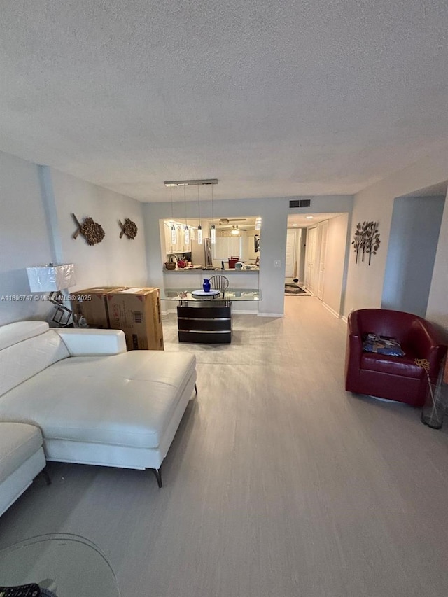7443 Fairfax Dr Unit 208, Tamarac, FL 33321 - living room with wood finished floors and a textured ceiling