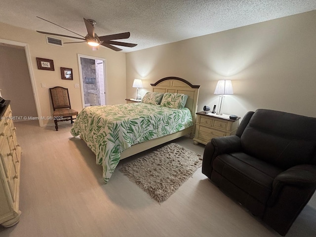 7443 Fairfax Dr Unit 208, Tamarac, FL 33321 - bedroom featuring a textured ceiling, a ceiling fan, and light wood finished floors