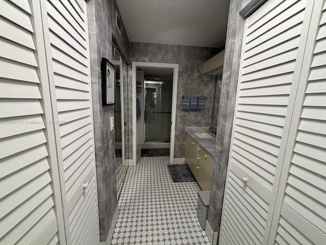 7443 Fairfax Dr Unit 208, Tamarac, FL 33321 - bathroom featuring vanity, a closet, a textured ceiling, and a shower stall