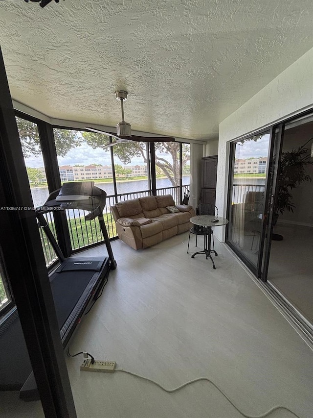 7443 Fairfax Dr Unit 208, Tamarac, FL 33321 - sunroom with a water view, a textured ceiling, wood finished floors, and an outdoor hangout area