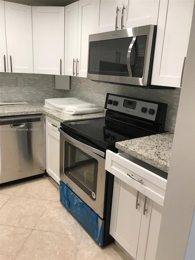 200 178th Dr Unit 505, Sunny Isles Beach, FL 33160 - kitchen featuring stainless steel appliances, backsplash, and white cabinetry