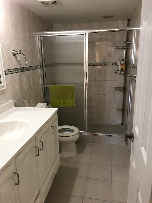 200 178th Dr Unit 505, Sunny Isles Beach, FL 33160 - bathroom featuring vanity, toilet, a stall shower, and tile patterned flooring