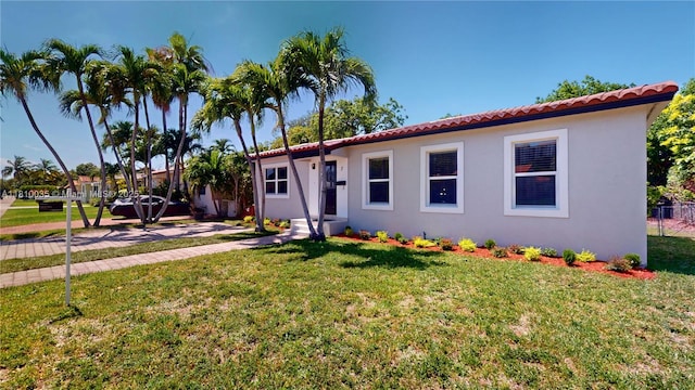 7 Montilla Ave, Coral Gables, FL 33134 - mediterranean / spanish home featuring a tile roof, stucco siding, and a front lawn