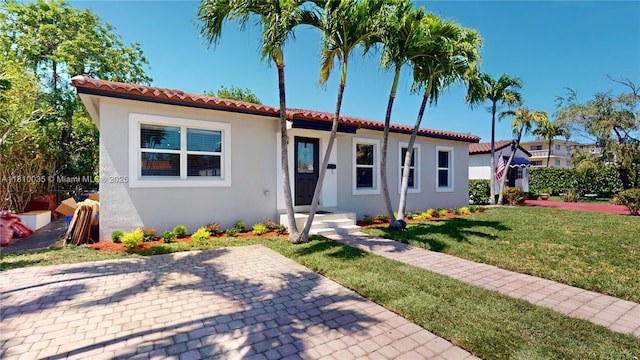 7 Montilla Ave, Coral Gables, FL 33134 - mediterranean / spanish-style house featuring stucco siding, a front yard, and a tile roof