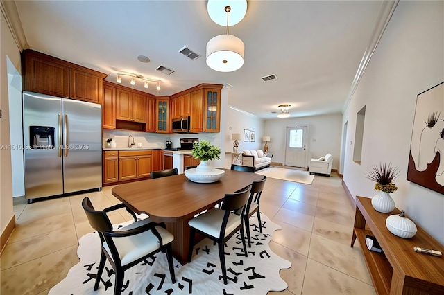 7 Montilla Ave, Coral Gables, FL 33134 - dining area featuring crown molding, light tile patterned floors, and baseboards