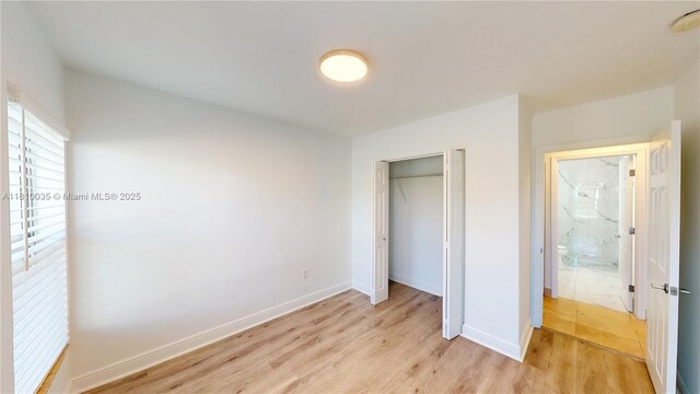 7 Montilla Ave, Coral Gables, FL 33134 - unfurnished bedroom featuring light wood-style floors, baseboards, and a closet