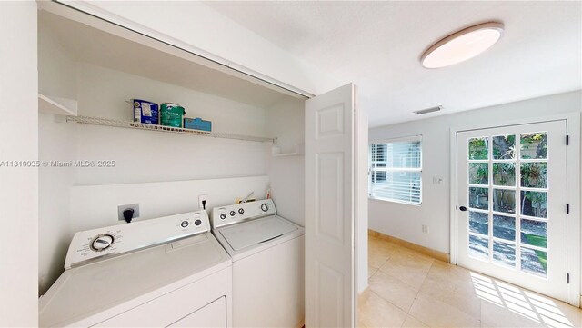 7 Montilla Ave, Coral Gables, FL 33134 - laundry area with washer and dryer and light tile patterned floors