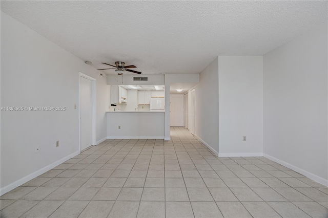 540 Brickell Key Dr Unit 718, Miami, FL 33131 - unfurnished living room with a textured ceiling, a ceiling fan, baseboards, and light tile patterned floors