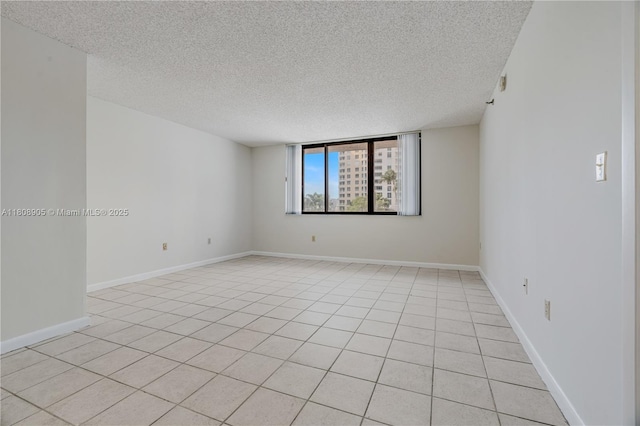 540 Brickell Key Dr Unit 718, Miami, FL 33131 - spare room with a textured ceiling, light tile patterned floors, and baseboards