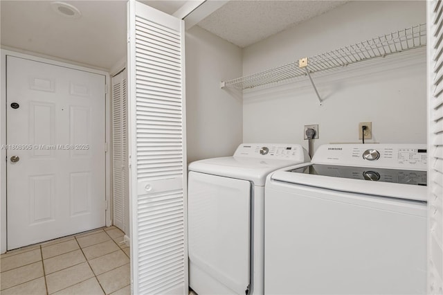 540 Brickell Key Dr Unit 718, Miami, FL 33131 - laundry area featuring separate washer and dryer and light tile patterned floors