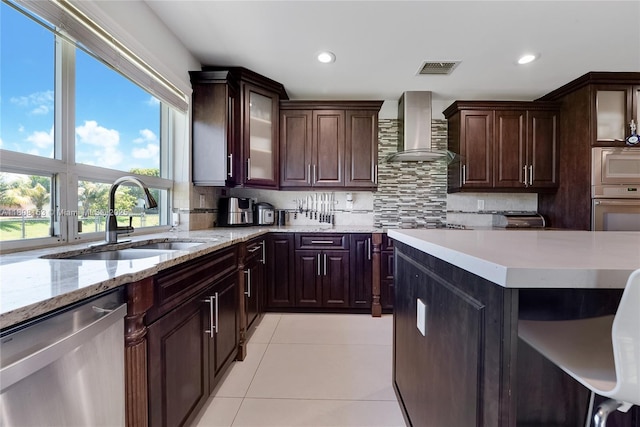 8005 SW 106th St, Miami, FL 33156 - kitchen featuring wall chimney exhaust hood, appliances with stainless steel finishes, a sink, light tile patterned floors, and decorative backsplash