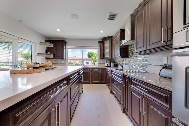8005 SW 106th St, Miami, FL 33156 - kitchen featuring backsplash, wall chimney range hood, dark brown cabinetry, light tile patterned flooring, and recessed lighting