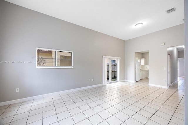 1005 NE 41st Ave, Homestead, FL 33033 - spare room with light tile patterned floors, baseboards, and a high ceiling