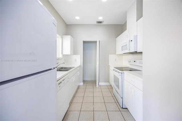 1005 NE 41st Ave, Homestead, FL 33033 - kitchen with white appliances, a sink, white cabinetry, light countertops, and baseboards
