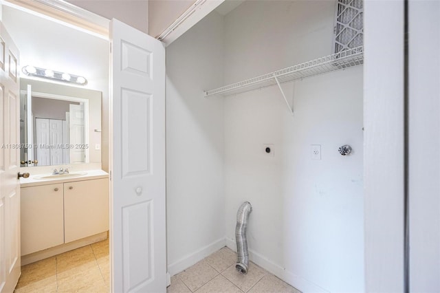 1005 NE 41st Ave, Homestead, FL 33033 - laundry area featuring electric dryer hookup, light tile patterned flooring, and baseboards