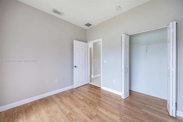 1005 NE 41st Ave, Homestead, FL 33033 - unfurnished bedroom with light wood-style floors, a closet, and baseboards