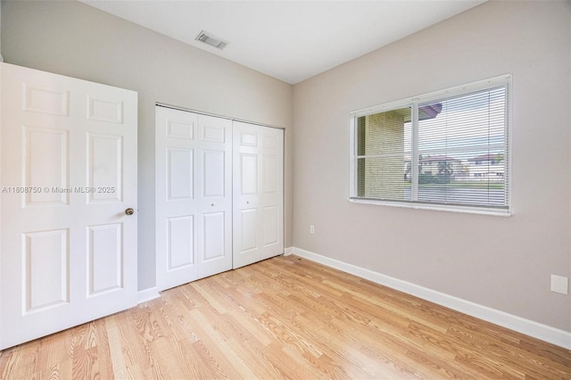 1005 NE 41st Ave, Homestead, FL 33033 - unfurnished bedroom featuring baseboards, light wood-type flooring, and a closet
