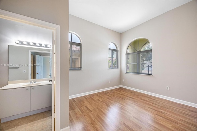 1005 NE 41st Ave, Homestead, FL 33033 - empty room with light wood-type flooring, baseboards, and a sink