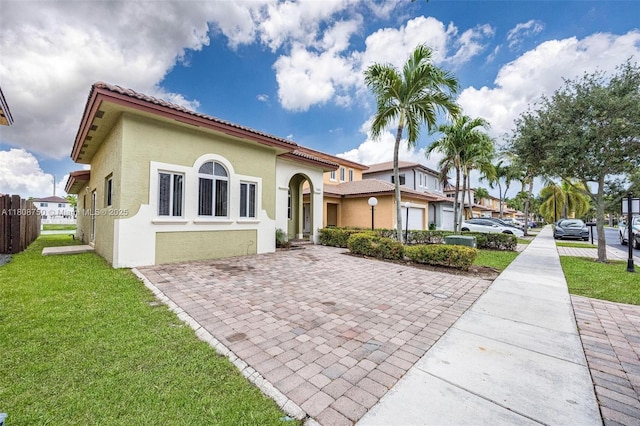 1005 NE 41st Ave, Homestead, FL 33033 - view of front of property with a front yard, stucco siding, and a tiled roof