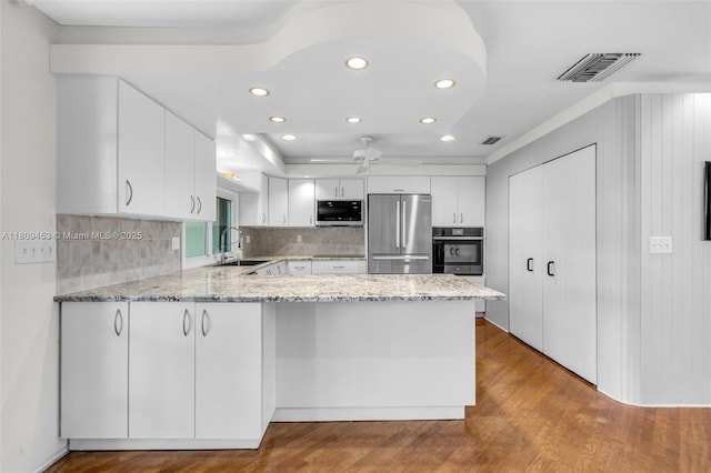 7619 SW 102nd Pl, Miami, FL 33173 - kitchen featuring appliances with stainless steel finishes, a sink, a peninsula, recessed lighting, and tasteful backsplash