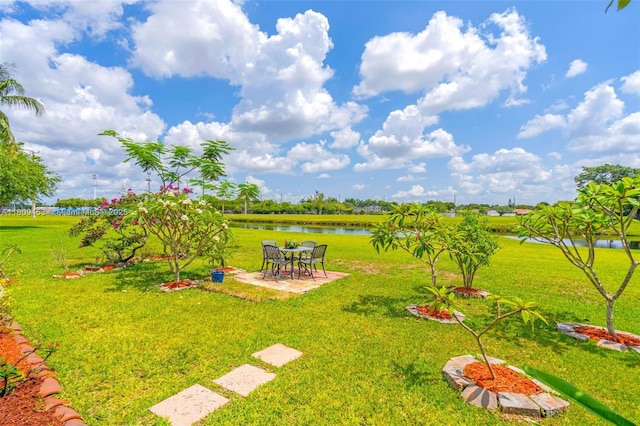 7619 SW 102nd Pl, Miami, FL 33173 - view of green lawn featuring a patio area and a water view