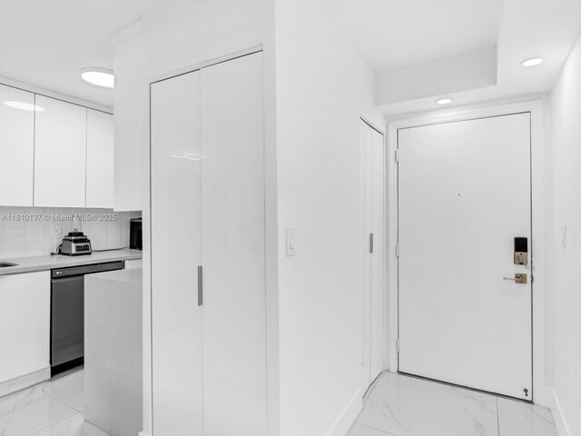 1890 W 56th St Unit 1307, Hialeah, FL 33012 - kitchen featuring white cabinets, dishwasher, light marble finish flooring, light countertops, and modern cabinets