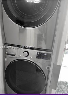 1890 W 56th St Unit 1307, Hialeah, FL 33012 - washroom featuring stacked washer and clothes dryer