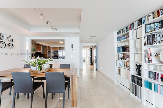 1331 Brickell Bay Dr Unit 2805, Miami, FL 33131 - dining room featuring a raised ceiling and track lighting