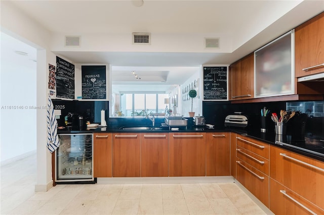 1331 Brickell Bay Dr Unit 2805, Miami, FL 33131 - kitchen with wine cooler, a sink, dark countertops, and backsplash