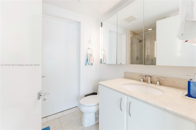 1331 Brickell Bay Dr Unit 2805, Miami, FL 33131 - bathroom featuring vanity, a shower stall, tile patterned flooring, and toilet