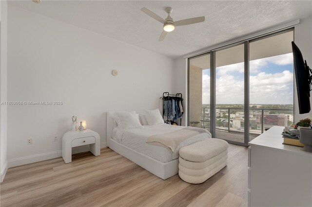 3470 E Coast Ave Unit H1402, Miami, FL 33137 - bedroom with access to exterior, expansive windows, light wood-type flooring, baseboards, and a ceiling fan
