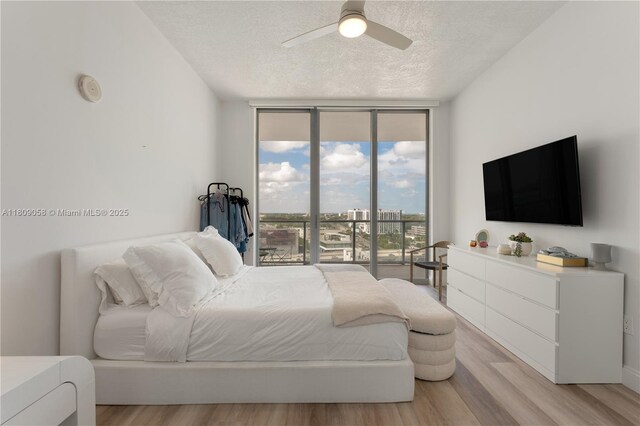 3470 E Coast Ave Unit H1402, Miami, FL 33137 - bedroom featuring floor to ceiling windows, access to outside, a textured ceiling, light wood-style floors, and a ceiling fan