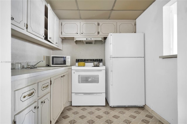 182 Westbury J 182, Deerfield Beach, FL 33442 - kitchen with white appliances, a drop ceiling, under cabinet range hood, light countertops, and white cabinetry
