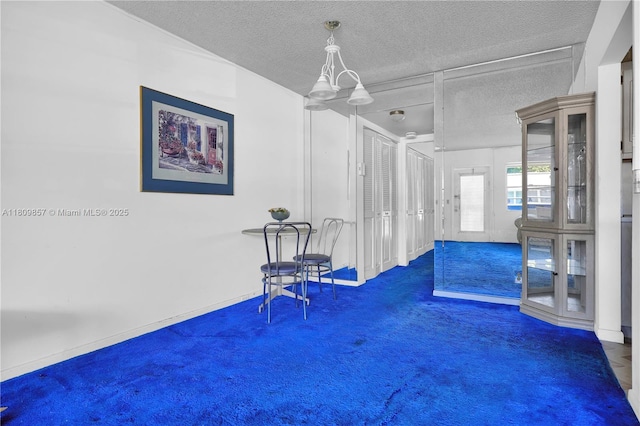182 Westbury J 182, Deerfield Beach, FL 33442 - unfurnished room featuring carpet floors, a textured ceiling, and a chandelier