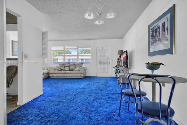 182 Westbury J 182, Deerfield Beach, FL 33442 - living area featuring carpet, a textured ceiling, and a chandelier