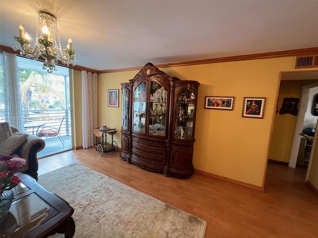 3551 NE 169th St Unit 301, North Miami Beach, FL 33160 - living area with a chandelier, wood finished floors, baseboards, and crown molding
